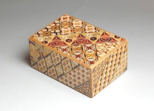 Yosegi puzzle box with a red, brown and cream wood mosaic