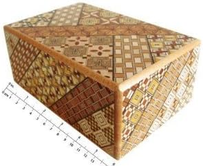 Larger yosegi puzzle box beside a ruler, showing mosaic bands